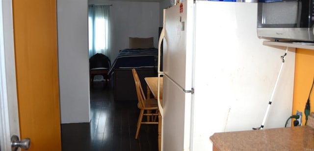 interior space with dark hardwood / wood-style flooring and white refrigerator