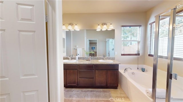 bathroom featuring vanity, independent shower and bath, and tile patterned flooring