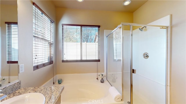 bathroom featuring vanity and shower with separate bathtub