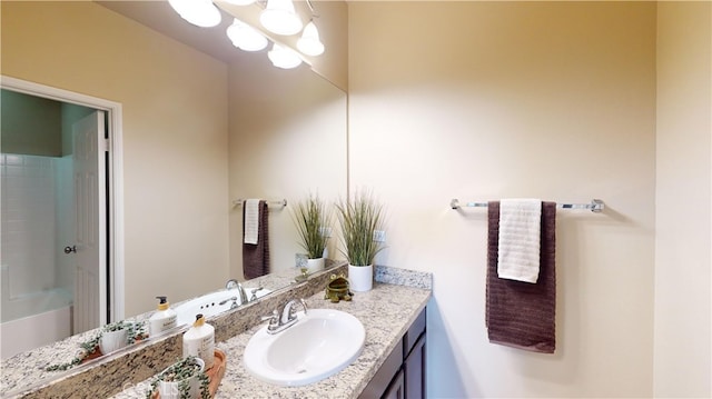 bathroom featuring a shower and vanity