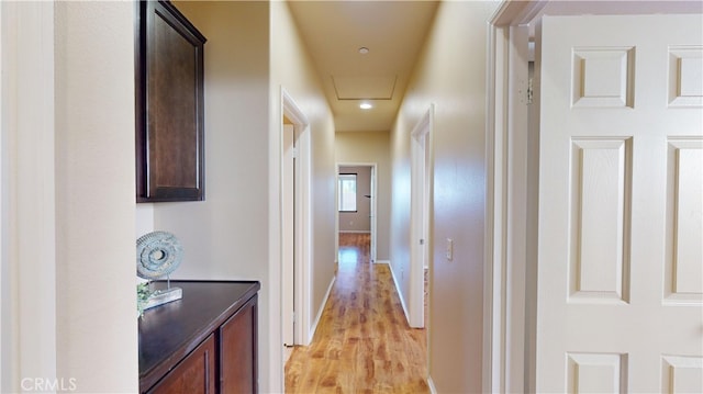 corridor with light hardwood / wood-style floors