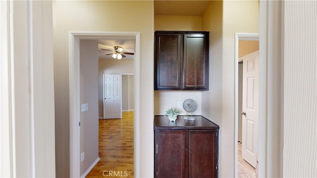 hallway with light hardwood / wood-style floors