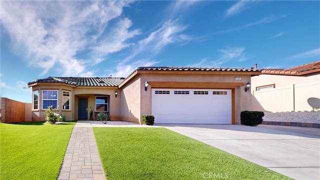 mediterranean / spanish-style home featuring a front lawn and a garage