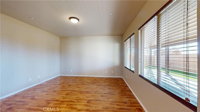 empty room with hardwood / wood-style floors