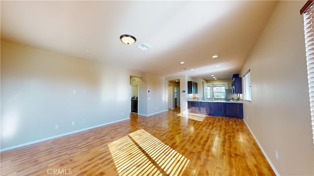 unfurnished living room with light wood-type flooring