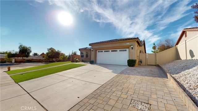 view of front of property featuring a garage and a front yard