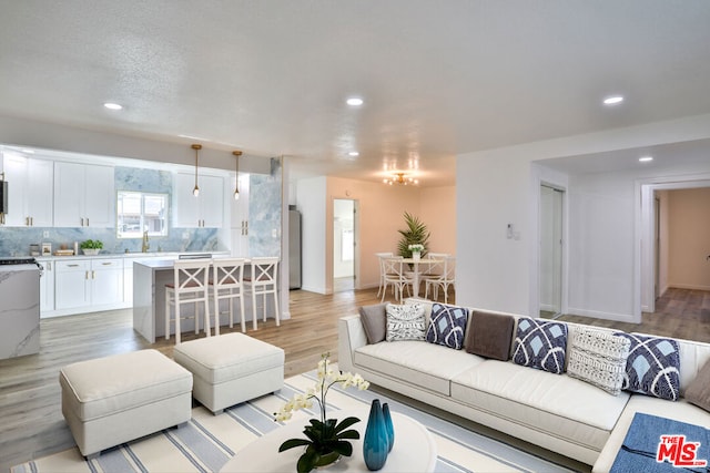 living room with sink and light hardwood / wood-style floors