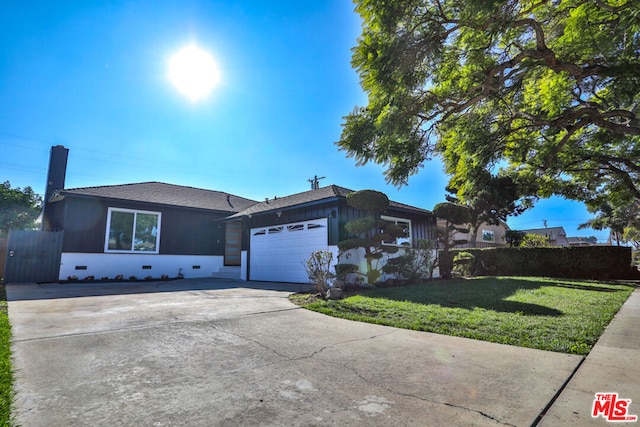 ranch-style home with a garage and a front lawn