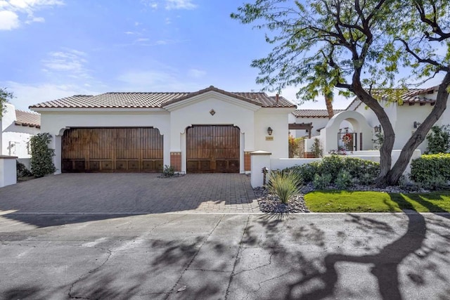 mediterranean / spanish-style house with a garage