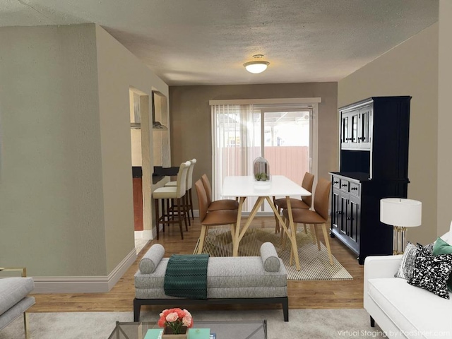 living room with hardwood / wood-style flooring and a textured ceiling