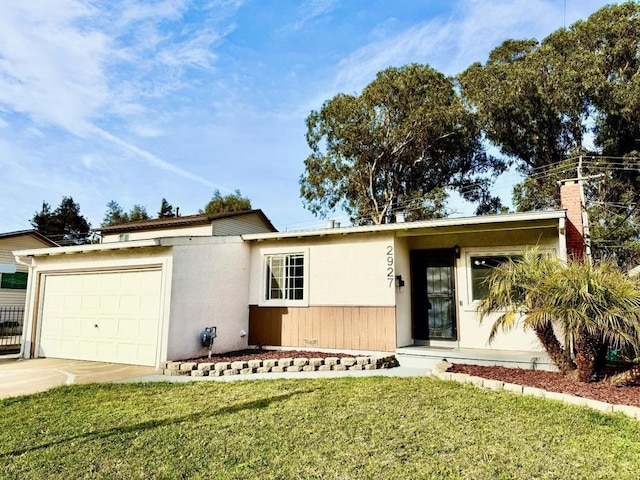 single story home featuring a garage and a front lawn