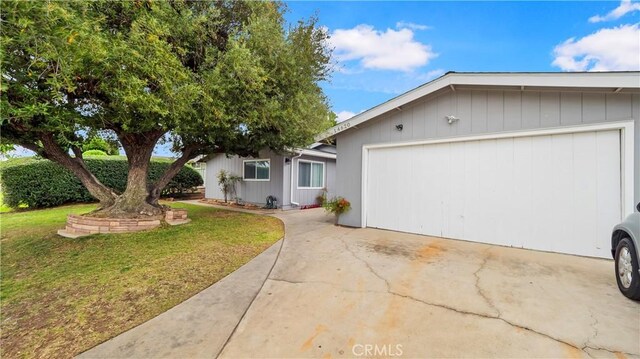 view of front of home with a garage and a front lawn