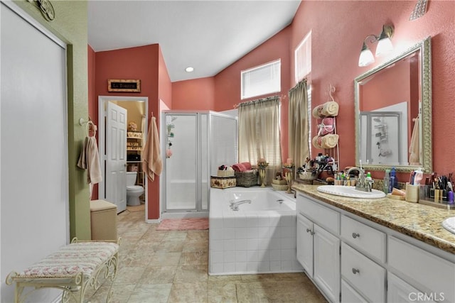 bathroom featuring vanity, independent shower and bath, and lofted ceiling