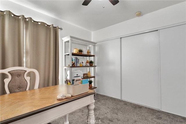 carpeted home office featuring ceiling fan