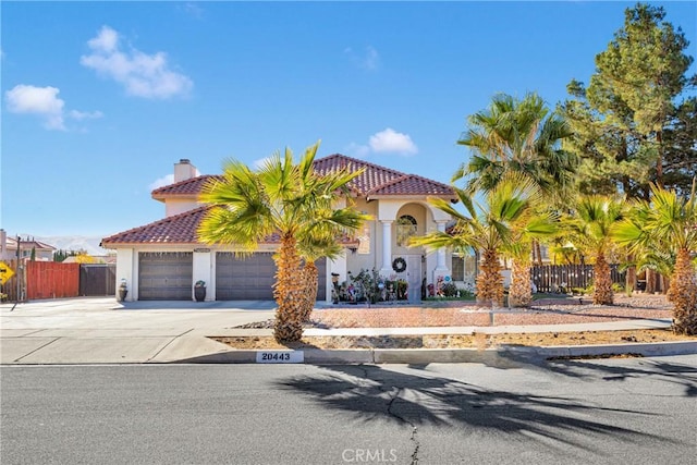 mediterranean / spanish house with a garage