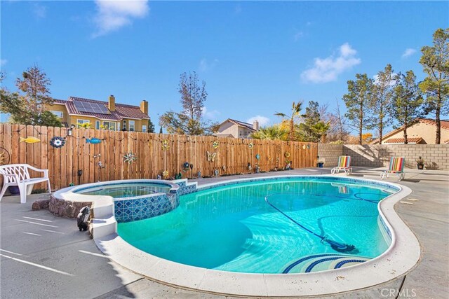 view of swimming pool featuring an in ground hot tub and a patio