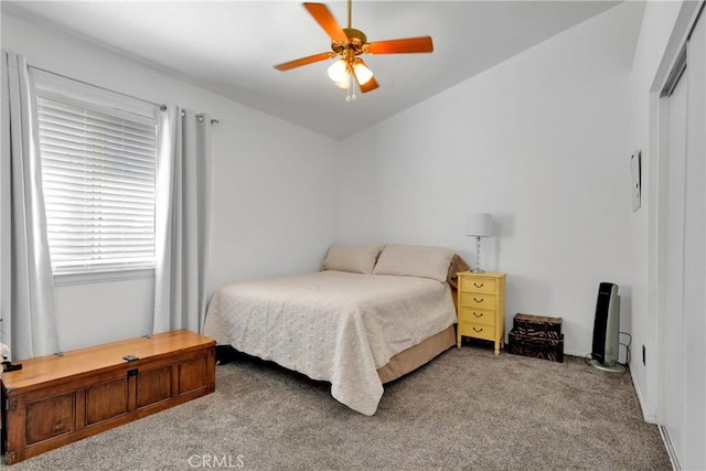 bedroom with ceiling fan, light colored carpet, and vaulted ceiling