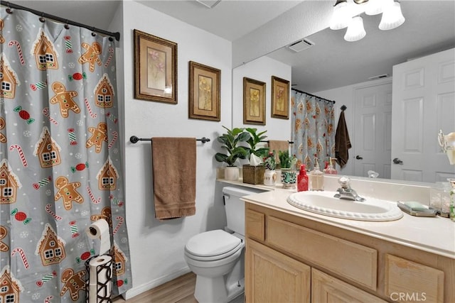 bathroom featuring hardwood / wood-style floors, vanity, a shower with shower curtain, and toilet