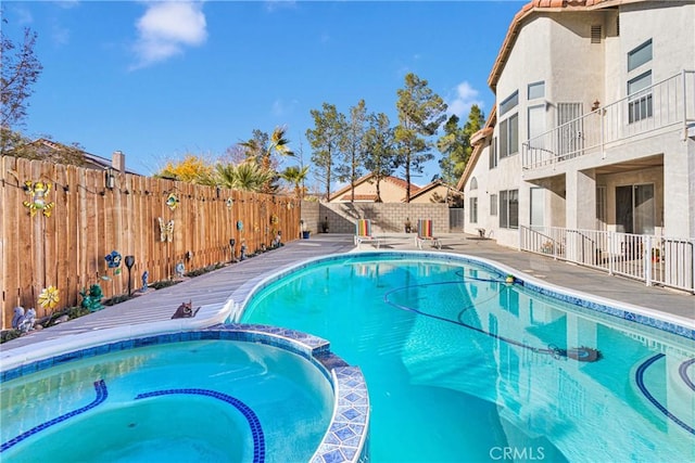 view of swimming pool featuring an in ground hot tub