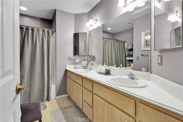 bathroom with vanity, tile patterned flooring, and shower / bathtub combination with curtain