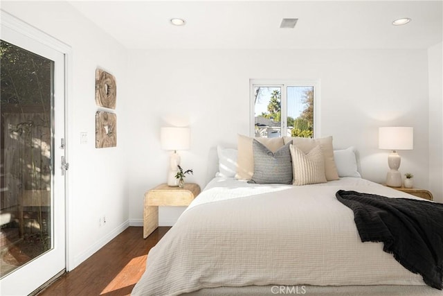 bedroom with dark hardwood / wood-style flooring