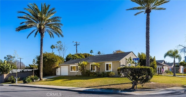 ranch-style home with a front yard and a garage