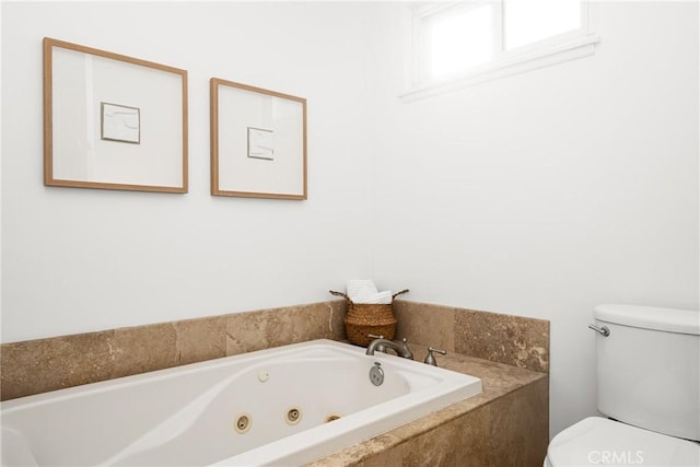 bathroom featuring toilet and tiled tub