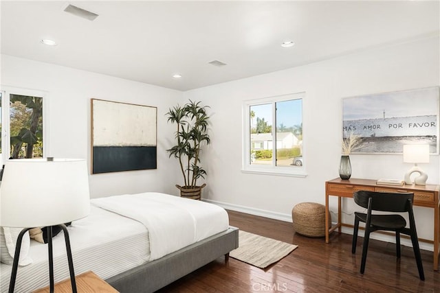 bedroom with dark hardwood / wood-style floors