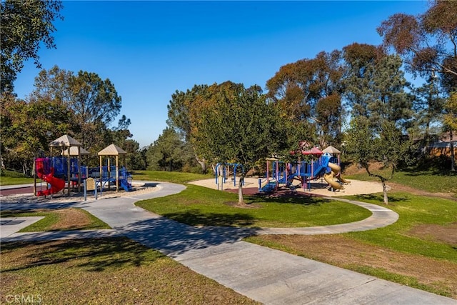 view of playground with a lawn