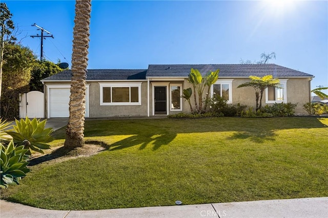 ranch-style house featuring a front lawn and a garage