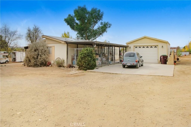 view of front facade with a garage and an outdoor structure