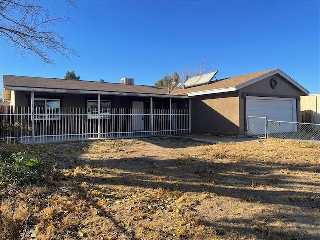 ranch-style house with a garage and central AC