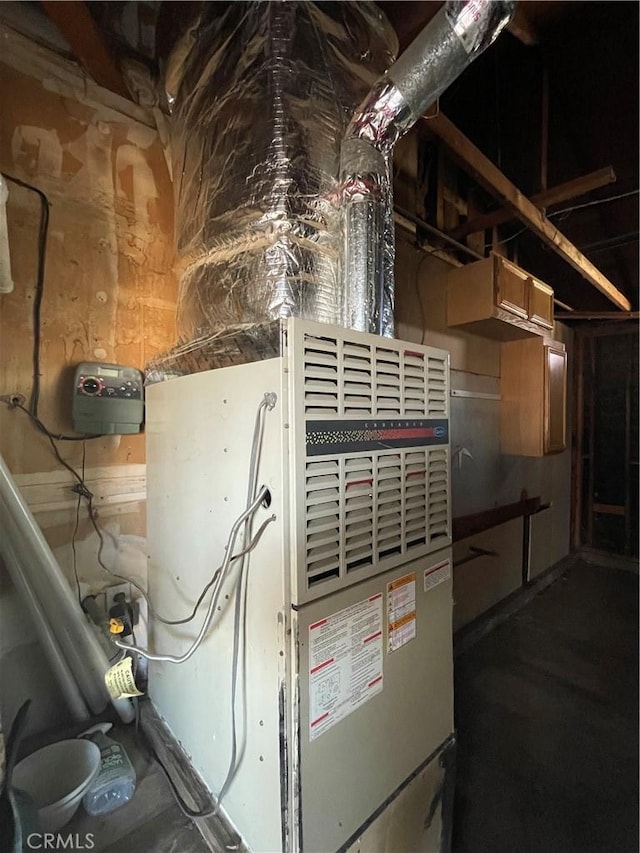 utility room featuring heating unit