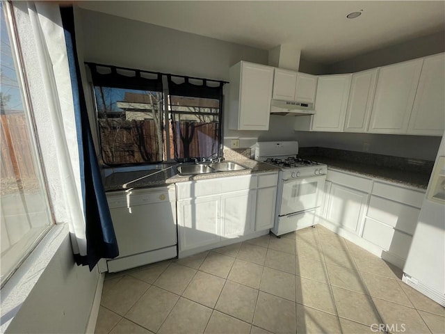 kitchen featuring white cabinetry, white appliances, sink, and a wealth of natural light