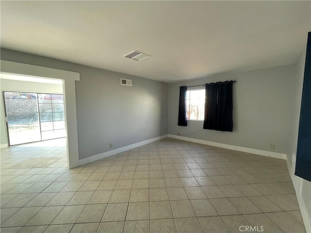 unfurnished room with light tile patterned floors