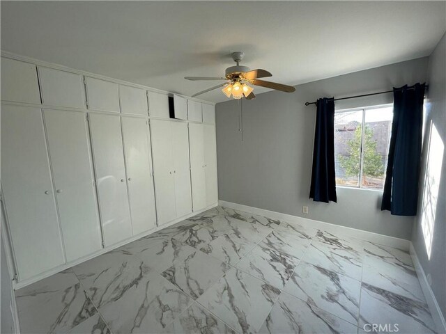 unfurnished bedroom featuring ceiling fan