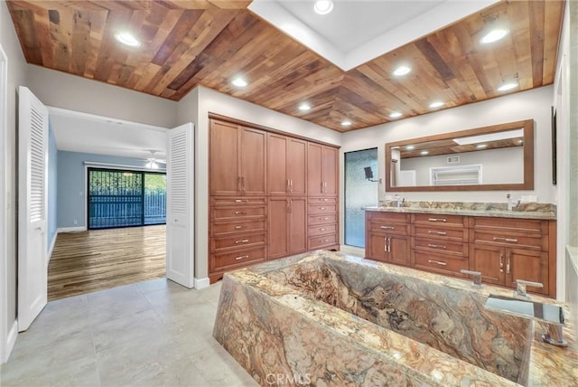 bathroom featuring vanity, hardwood / wood-style flooring, ceiling fan, and wood ceiling