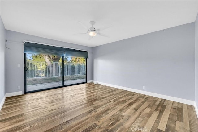 unfurnished room with ceiling fan and hardwood / wood-style flooring