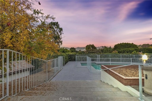 view of pool at dusk