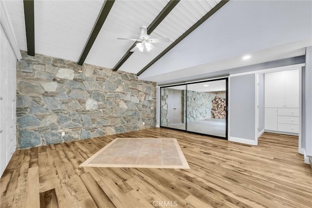 interior space featuring hardwood / wood-style flooring, ceiling fan, beam ceiling, and high vaulted ceiling