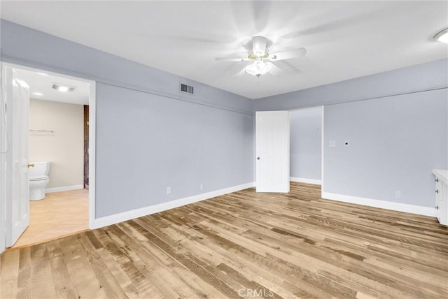 spare room featuring ceiling fan and light hardwood / wood-style flooring