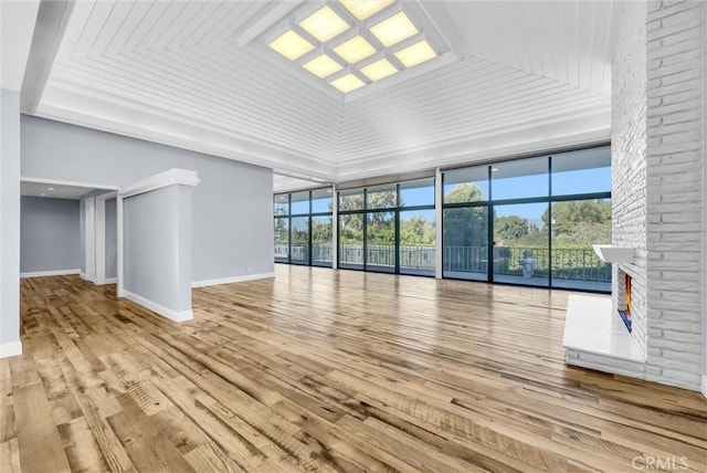 unfurnished living room featuring light hardwood / wood-style floors and high vaulted ceiling