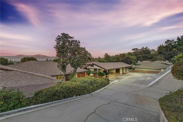 ranch-style home featuring concrete driveway