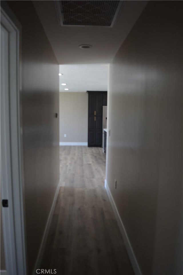 corridor with hardwood / wood-style floors