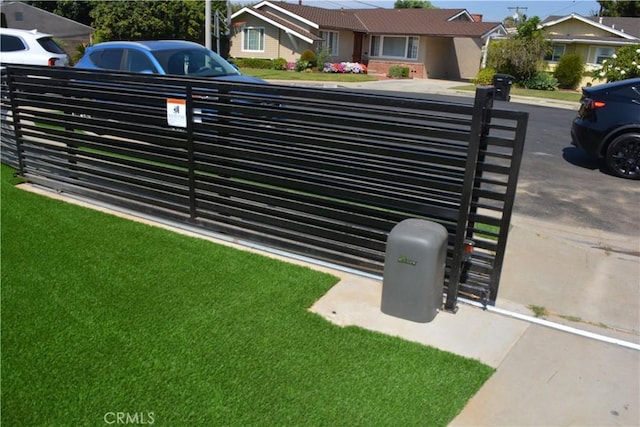 view of gate featuring a lawn