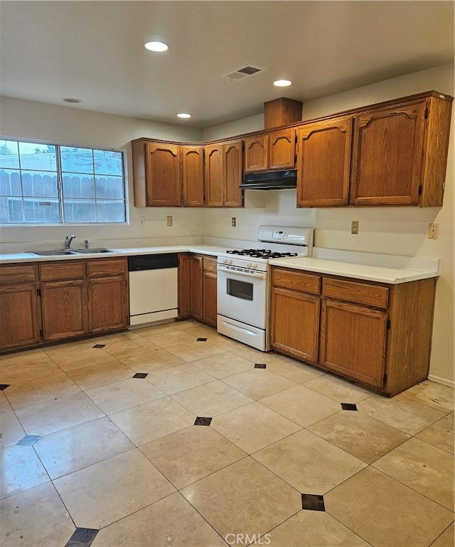 kitchen featuring white appliances and sink