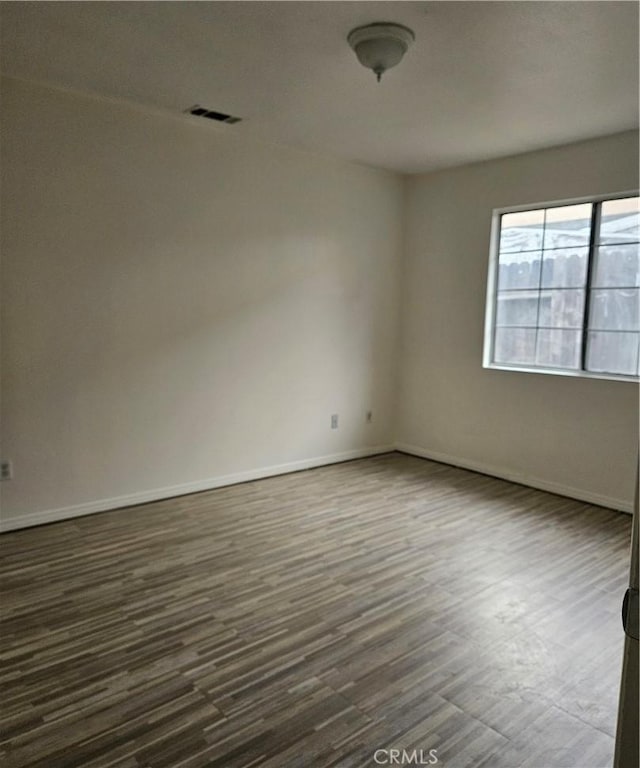 empty room featuring dark wood-type flooring