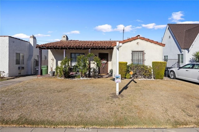 mediterranean / spanish-style house with a front lawn