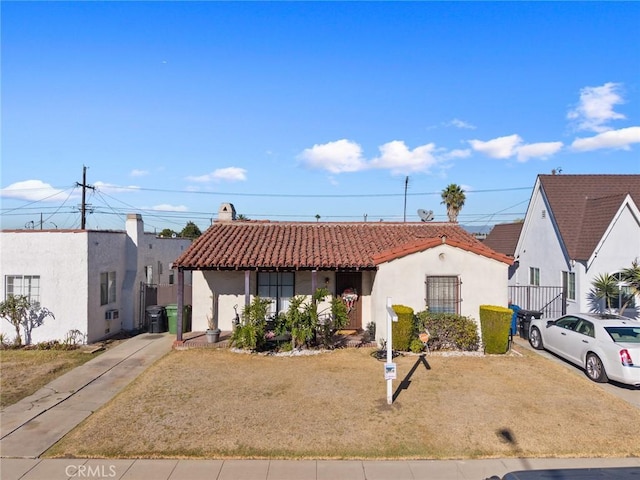 view of front of house with a front lawn and central AC unit