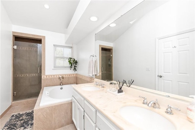 bathroom with tile patterned floors, vanity, and independent shower and bath